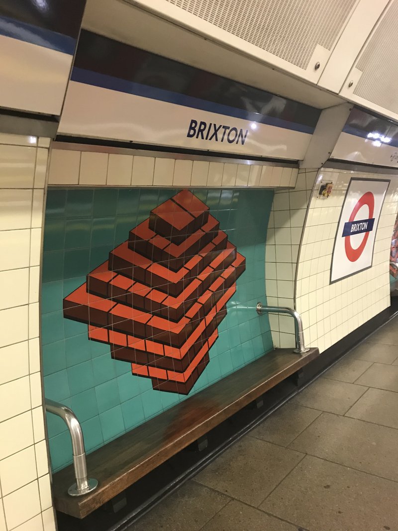 Brixton Tube Station。London北東部からThames Riverの南に至るVictoria Lineの南の終点。この壁画は、a ton of bricks →bricks ton → Brixton、、、だそうです😊