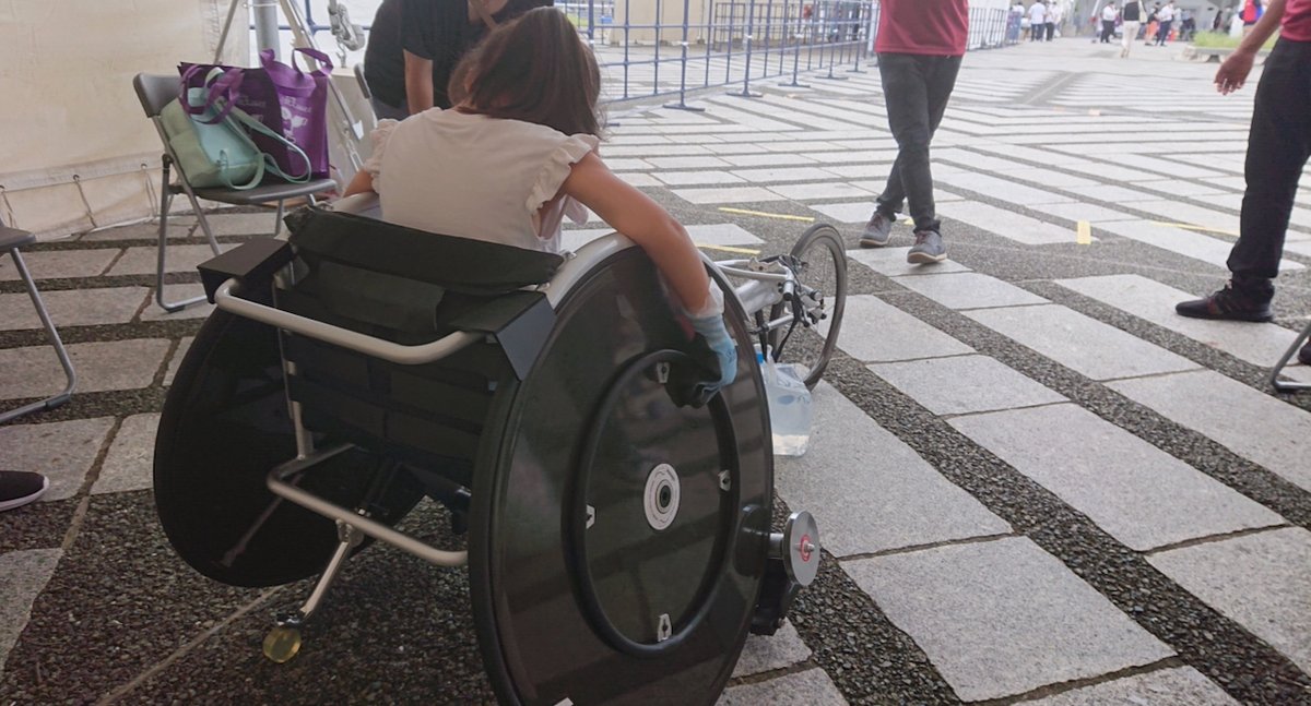 A girl trying out a racing wheelchair for para-athletics