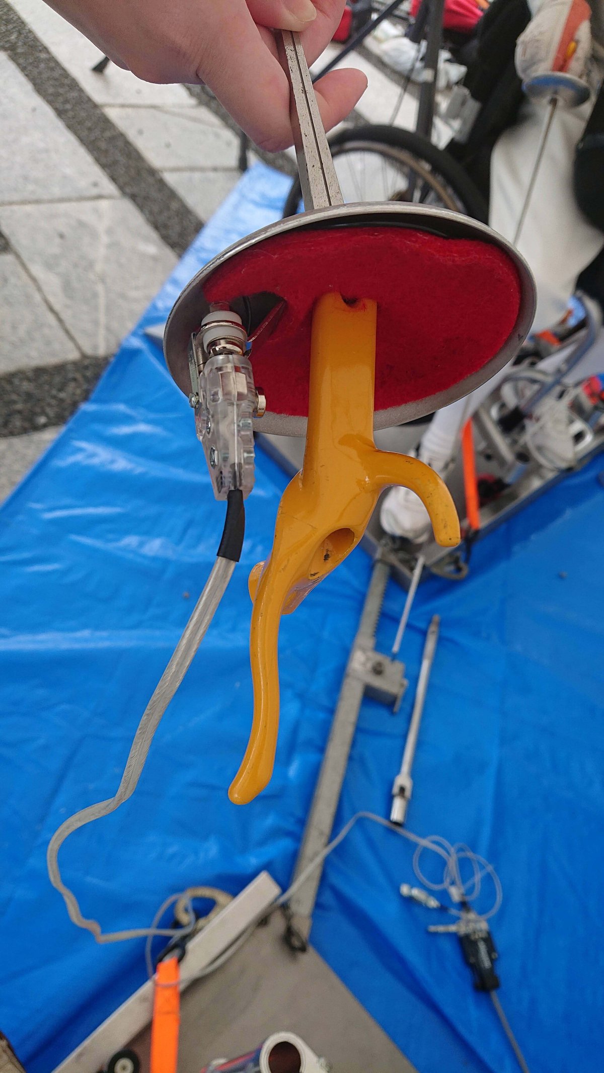 A fencing sabre. An electronic line is connected to it.