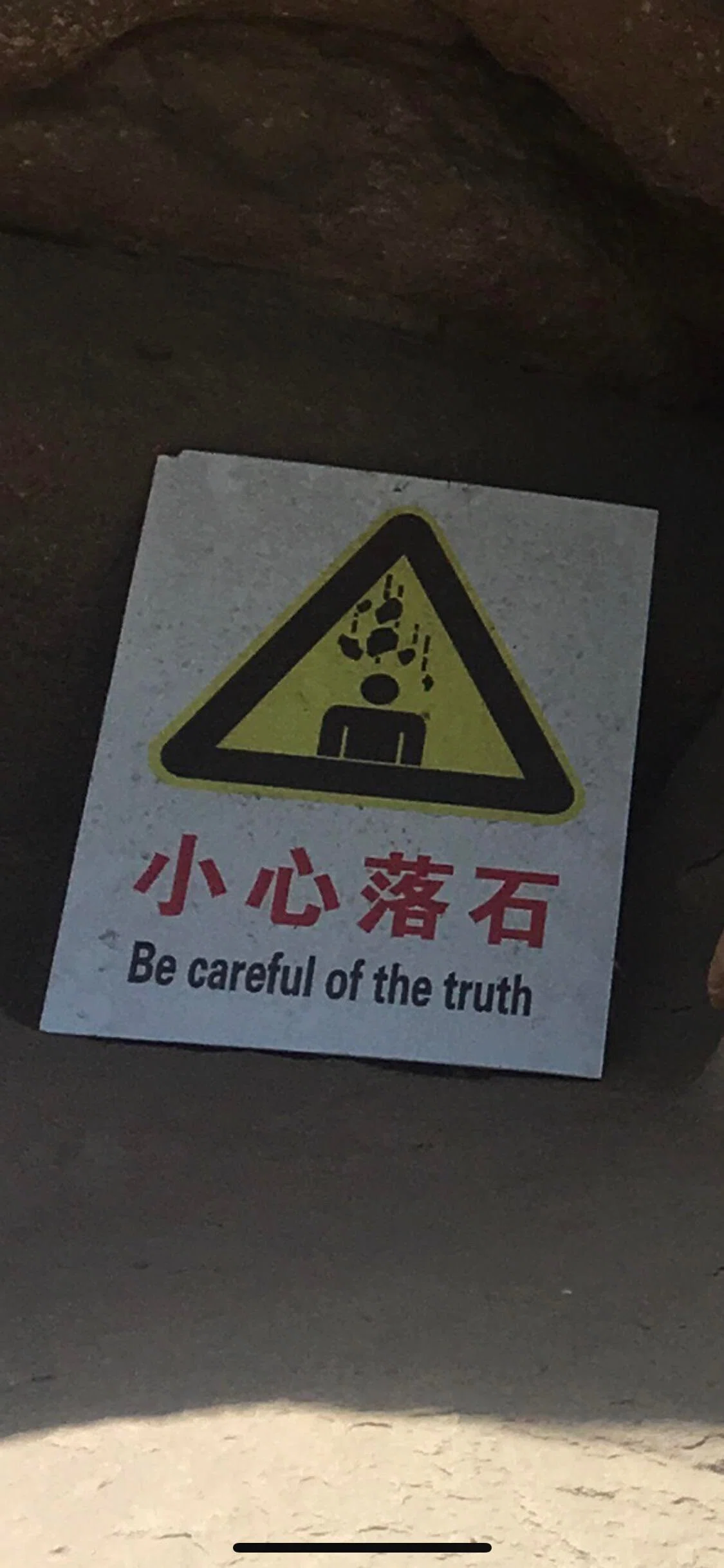 落石注意の看板に英語で「Be careful of the truth」