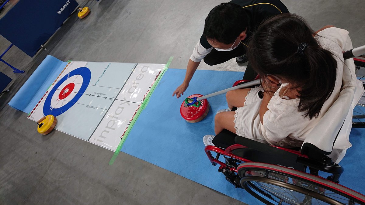 A girl trying out wheelchair curling