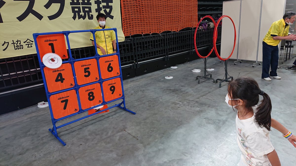 Girl trying strikeout with flying disc, hitting 2 and 3