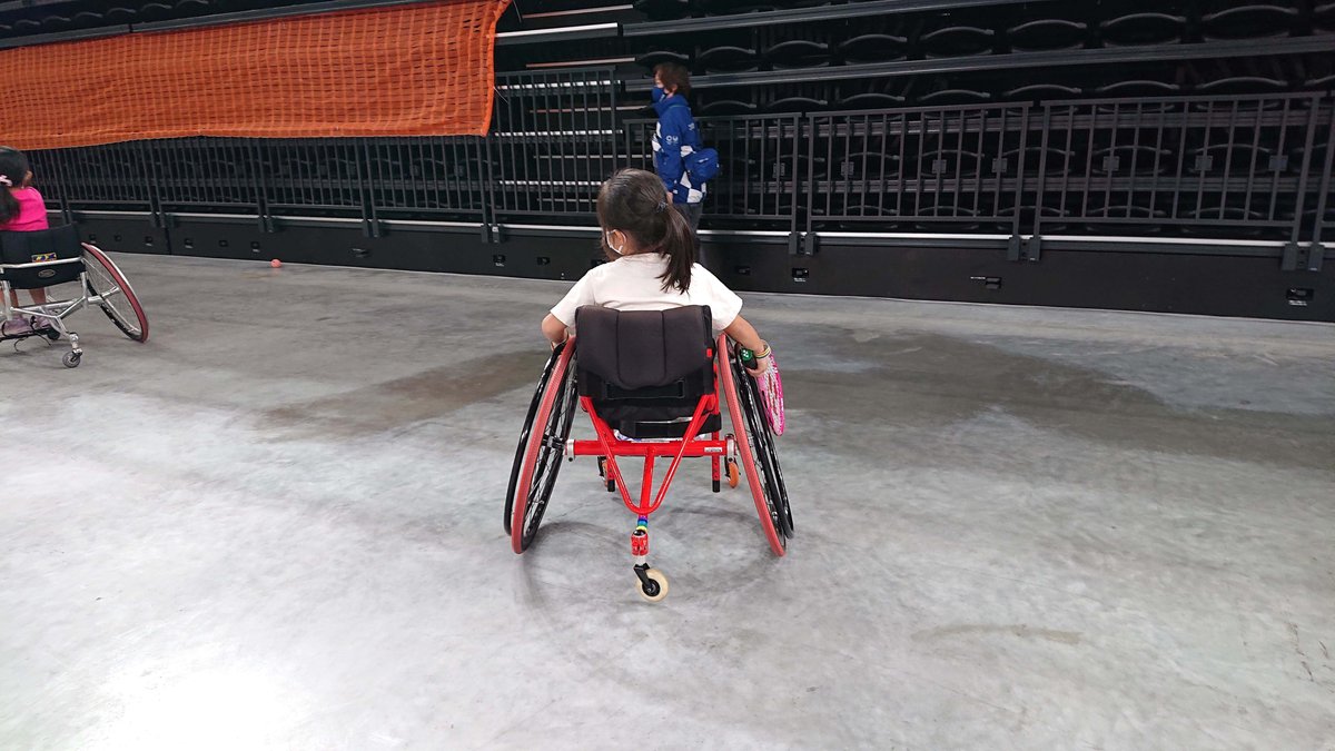A girl trying out wheelchair tennis