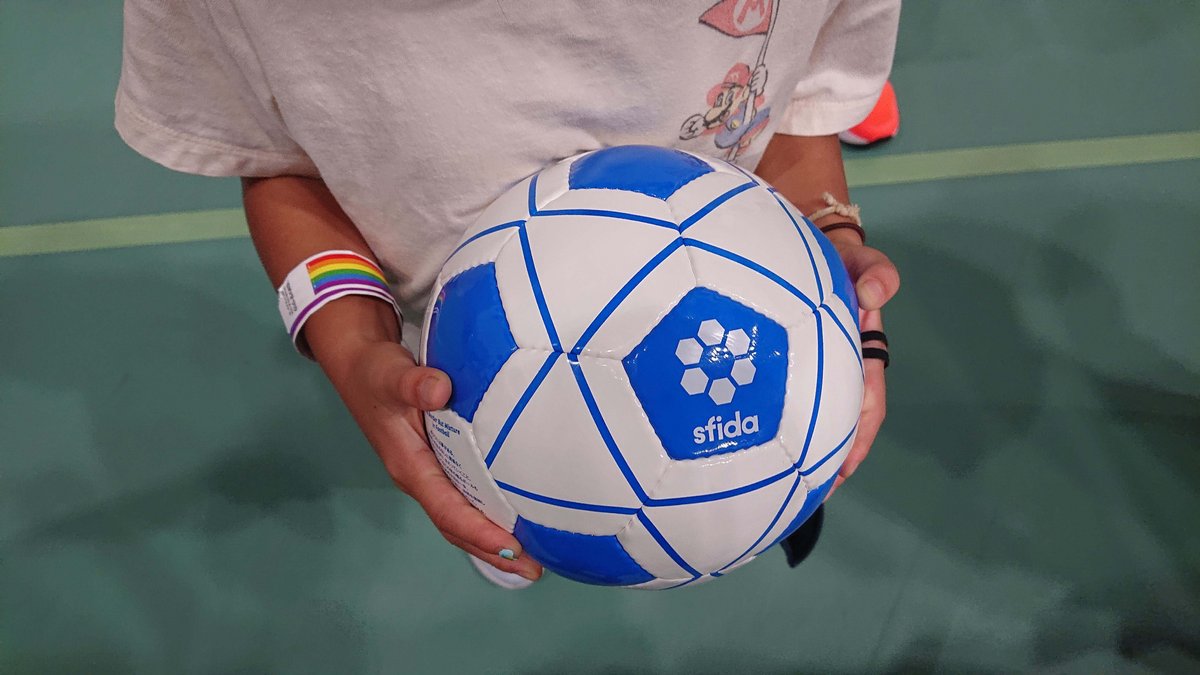 Girl holding a blind soccer ball