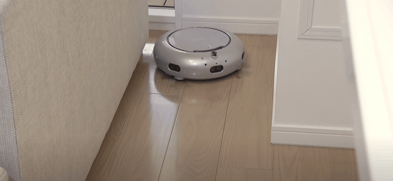 部屋の隅を頑張ってそうじするロボット掃除機 COCOROBO