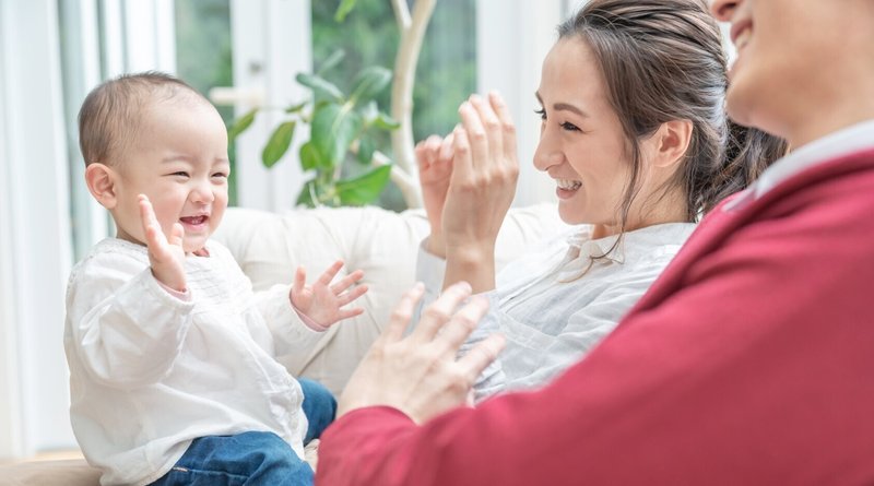 子どもと遊ぶ家族の画像