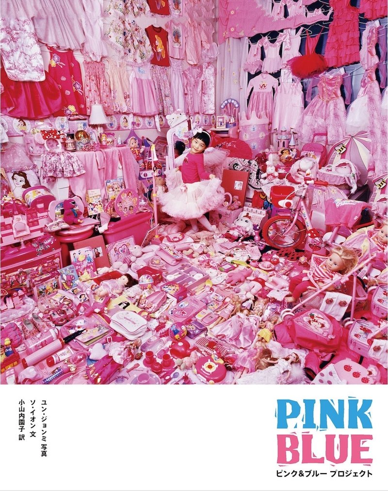 ピンクの服や小物で埋め尽くされた子供部屋の中心に少女がピンクのドレスを着て立っている写真の表紙　タイトル　PINK BLUE　ユン・ジョンミ写真　ソ・イオン文　小山内園子訳