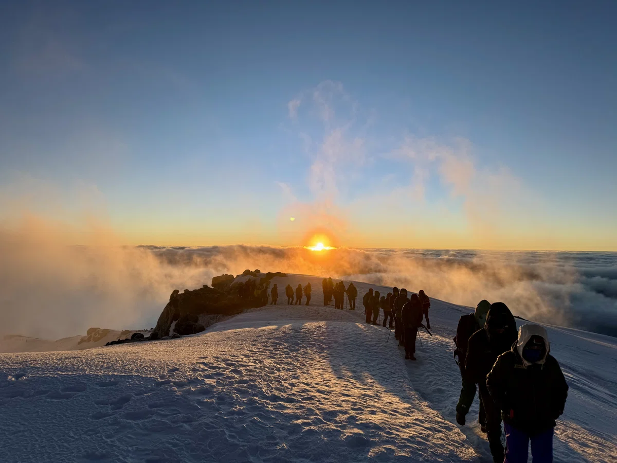 Climbers approaching the summit of Kilimanjaro at sunrise