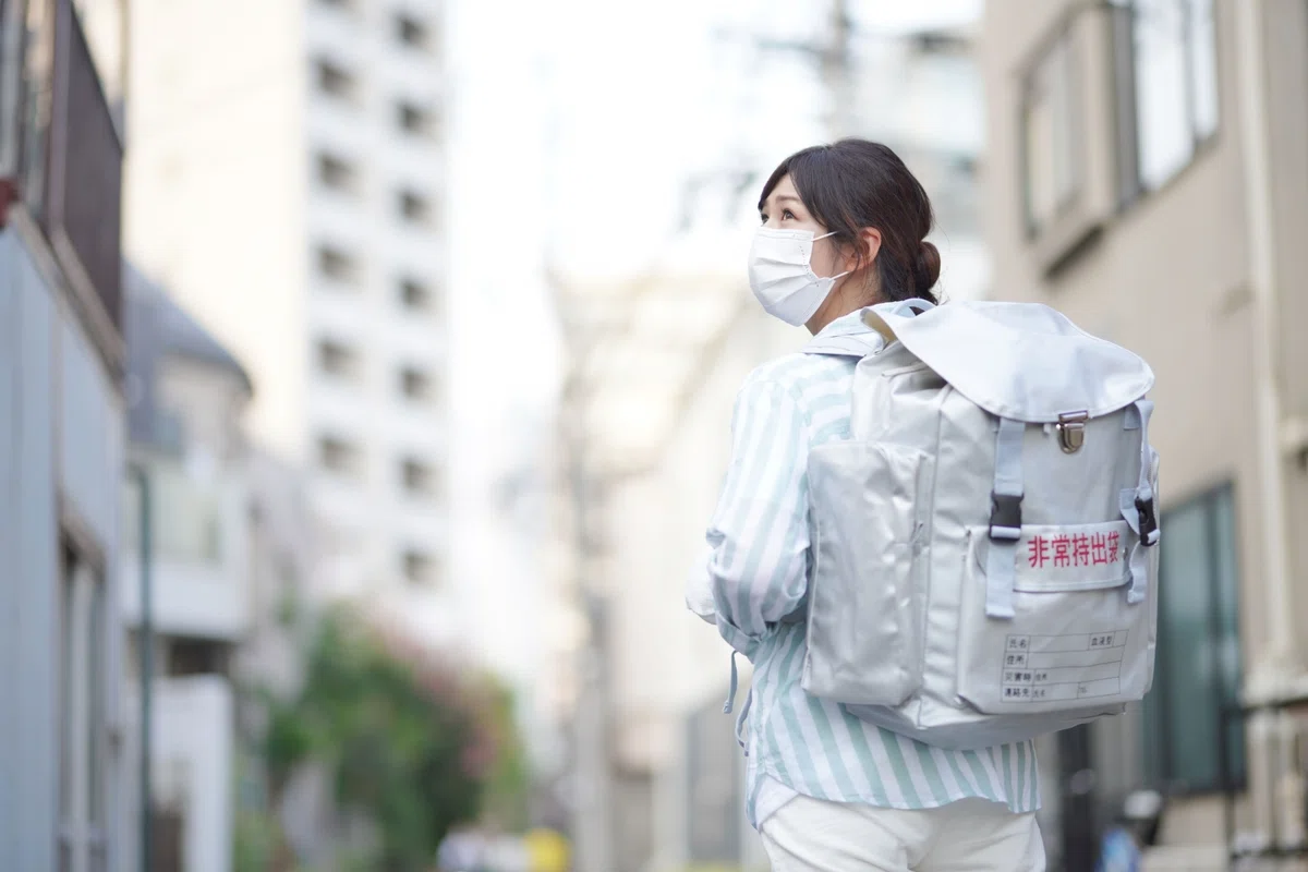 非常持出袋を背負う女性