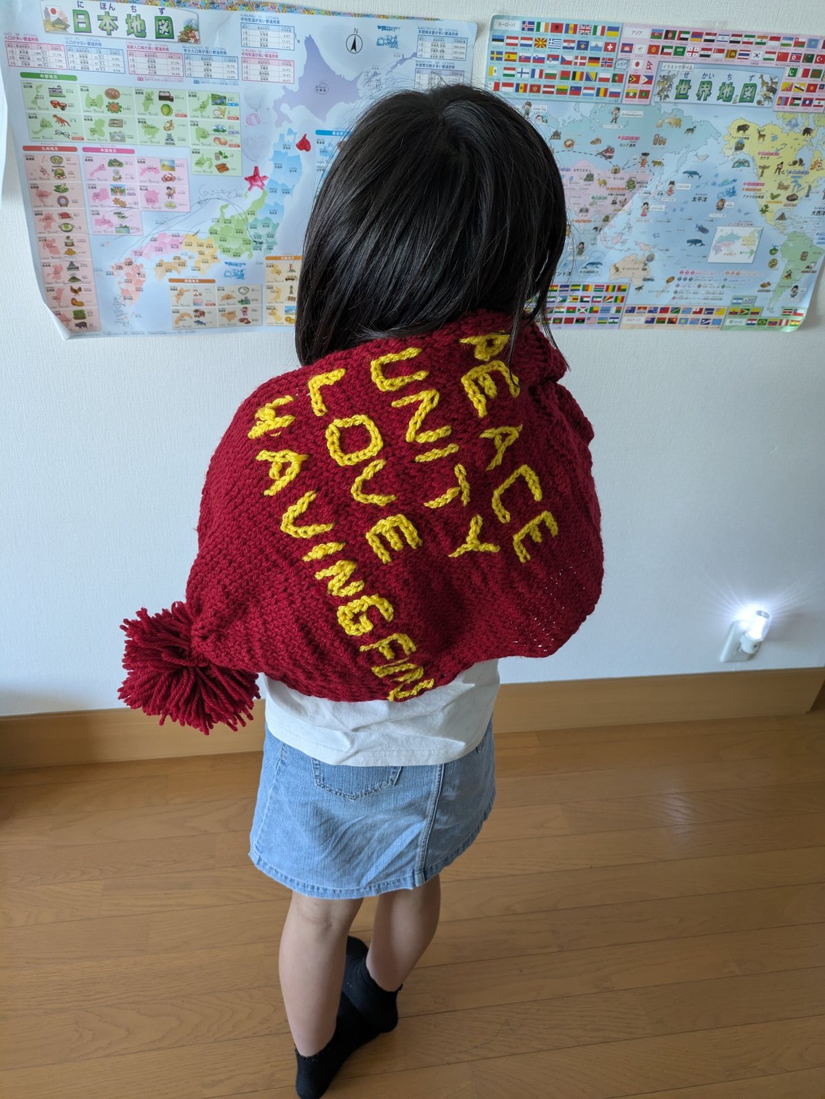 A girl is wearing a red scarf