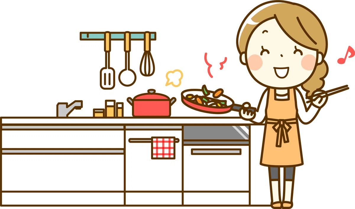 キッチンでご飯を作っている女性