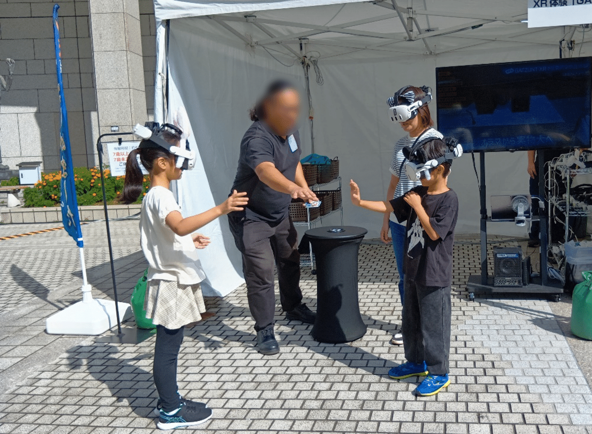 こどもが頭にVRゴーグル(白)をかけて体験する様子。