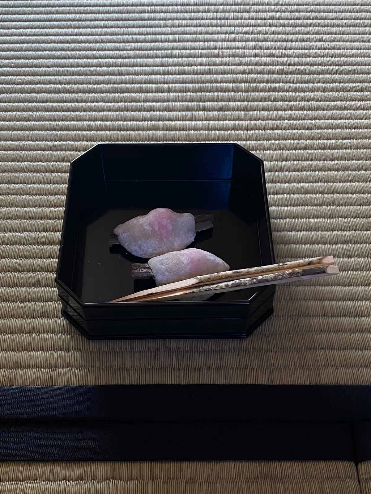 裏千家の初釜菓子「花びら餅」。黒塗りの縁高に入った、甘く煮た牛蒡と白味噌餡を求肥で包んだ伝統和菓子。