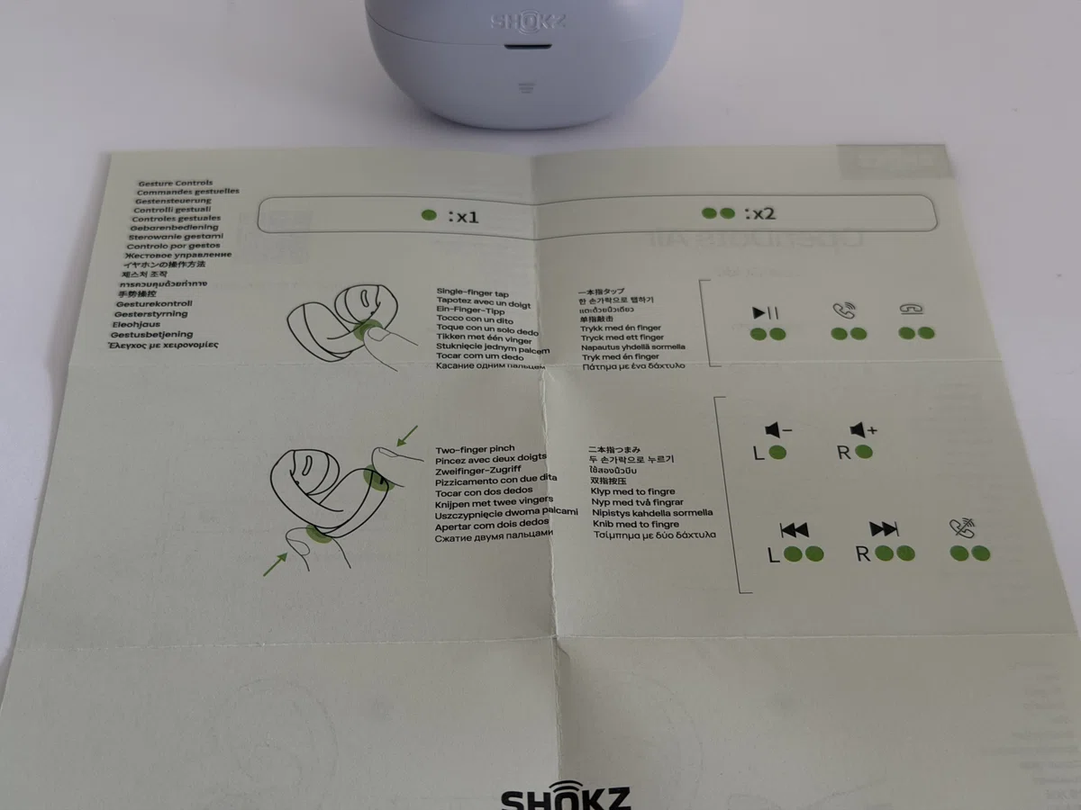 Shokz OpenDots Air デイブレイクパープル。耳に挟んで使うイヤーカフ型イヤホンの説明書。操作方法。