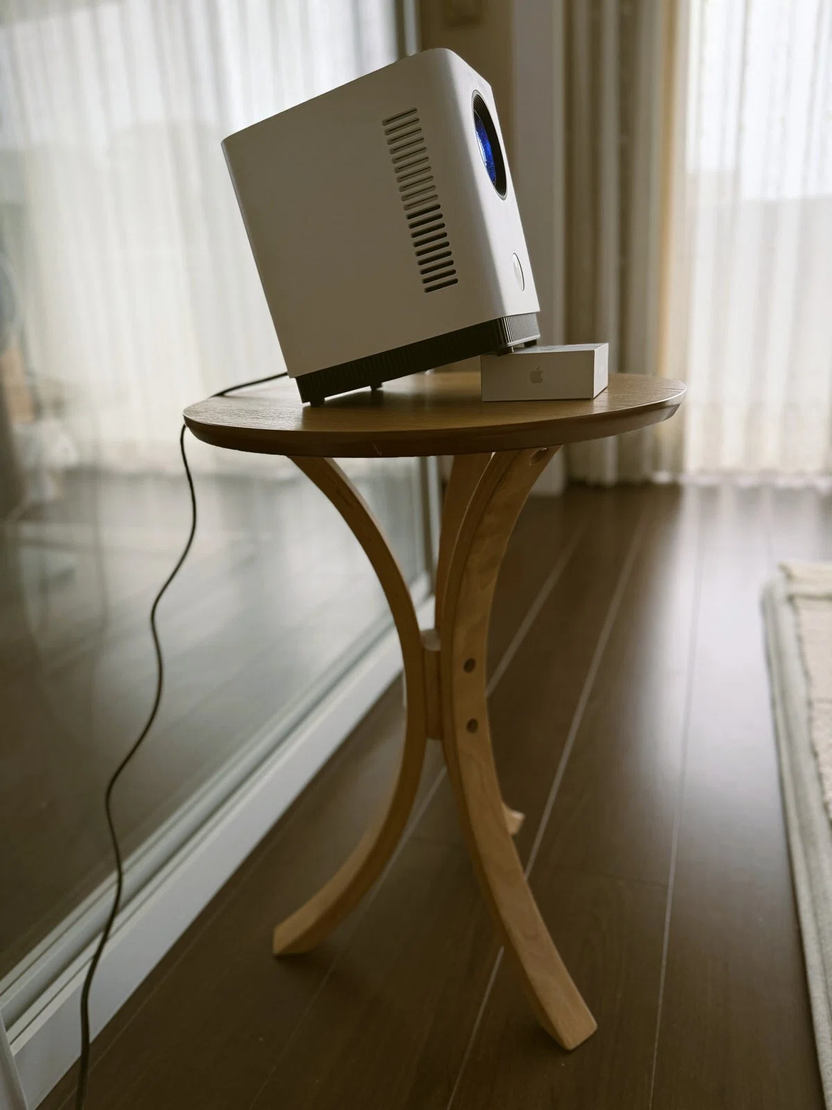 FPD CT04-A1の前足の下にAirPodsの外箱を敷き、投影角度を少し上向きに調整している様子。