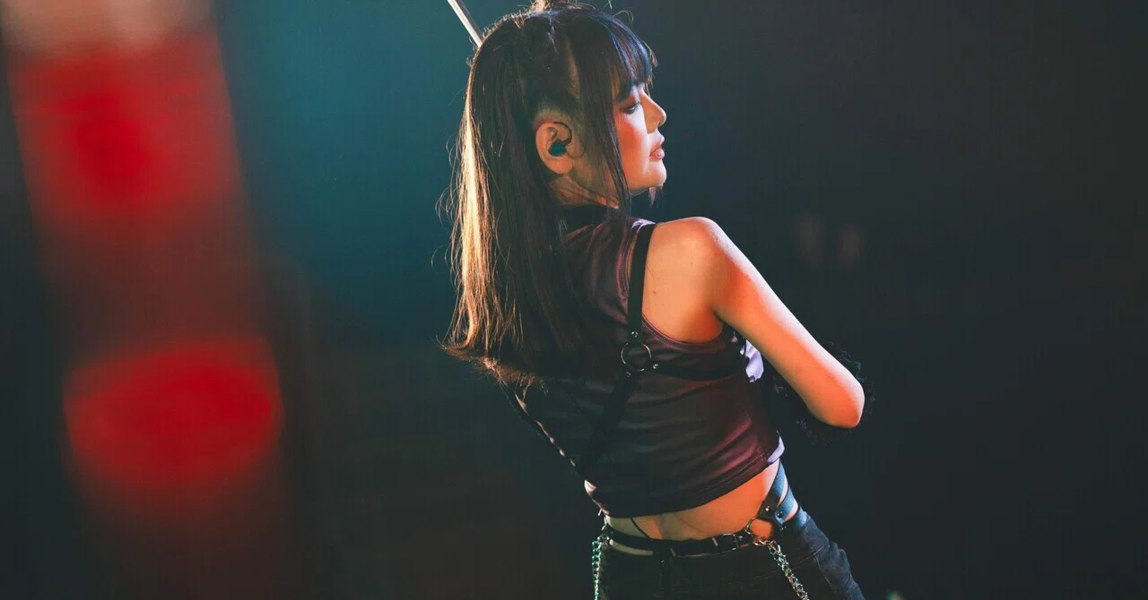 Jill captured from a dynamic back-angle live performance shot.
