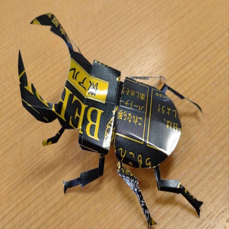 アルミ缶を切り開いて、クワガタ（鹿田式）の作り方を、子供たちに教え