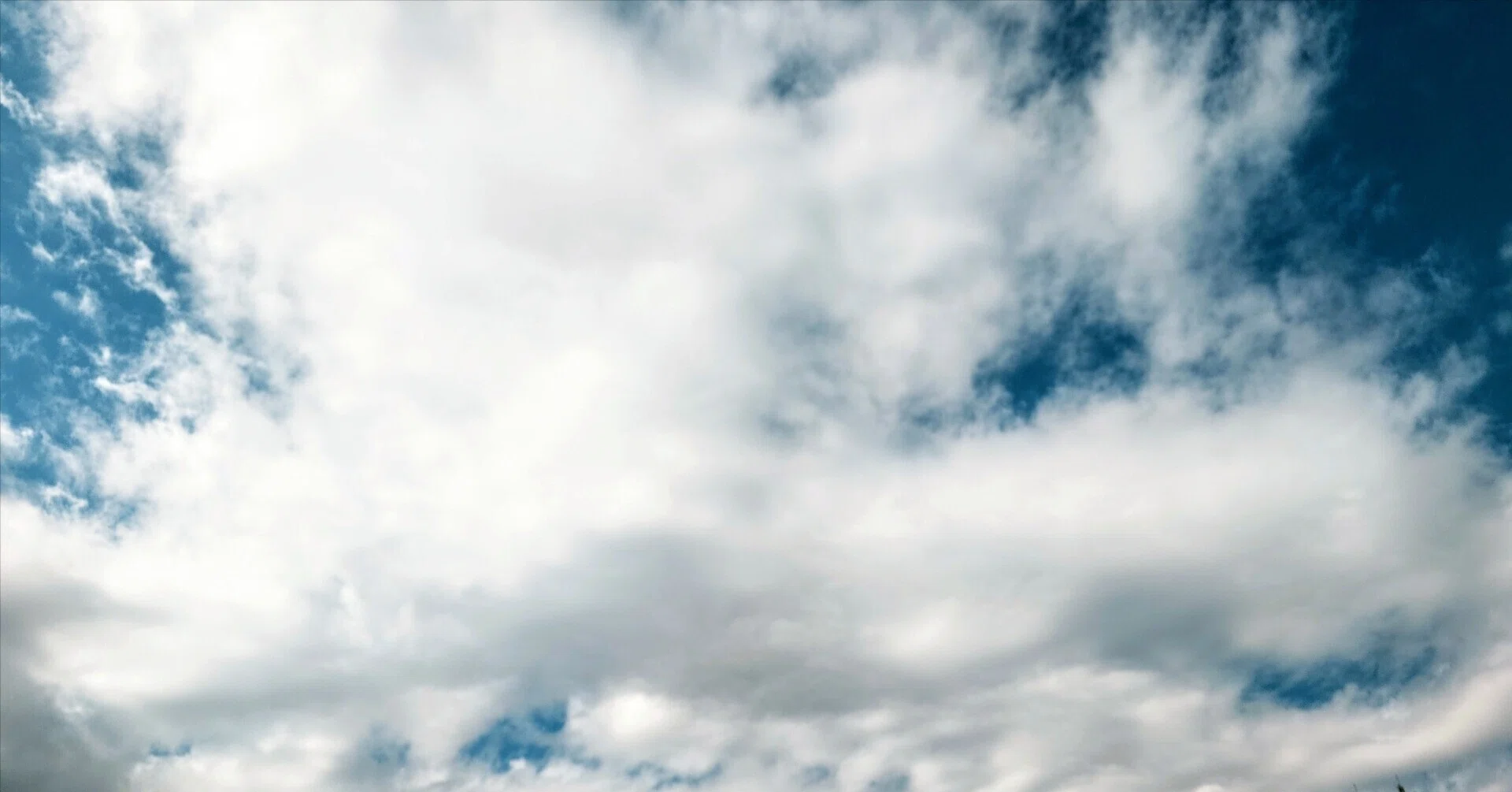 Drifting clouds change their shape as they continue their journey to a ...