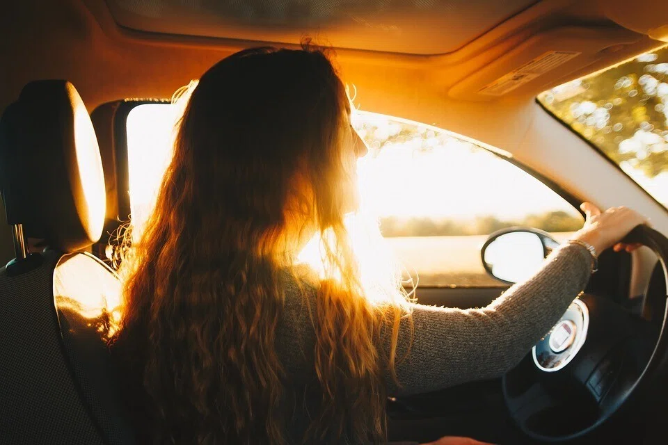 女性・車・運転・逆光